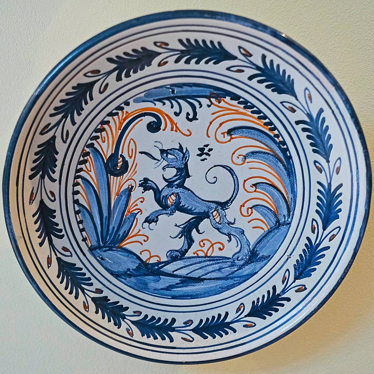 A blue and white plate with an animal at its centre