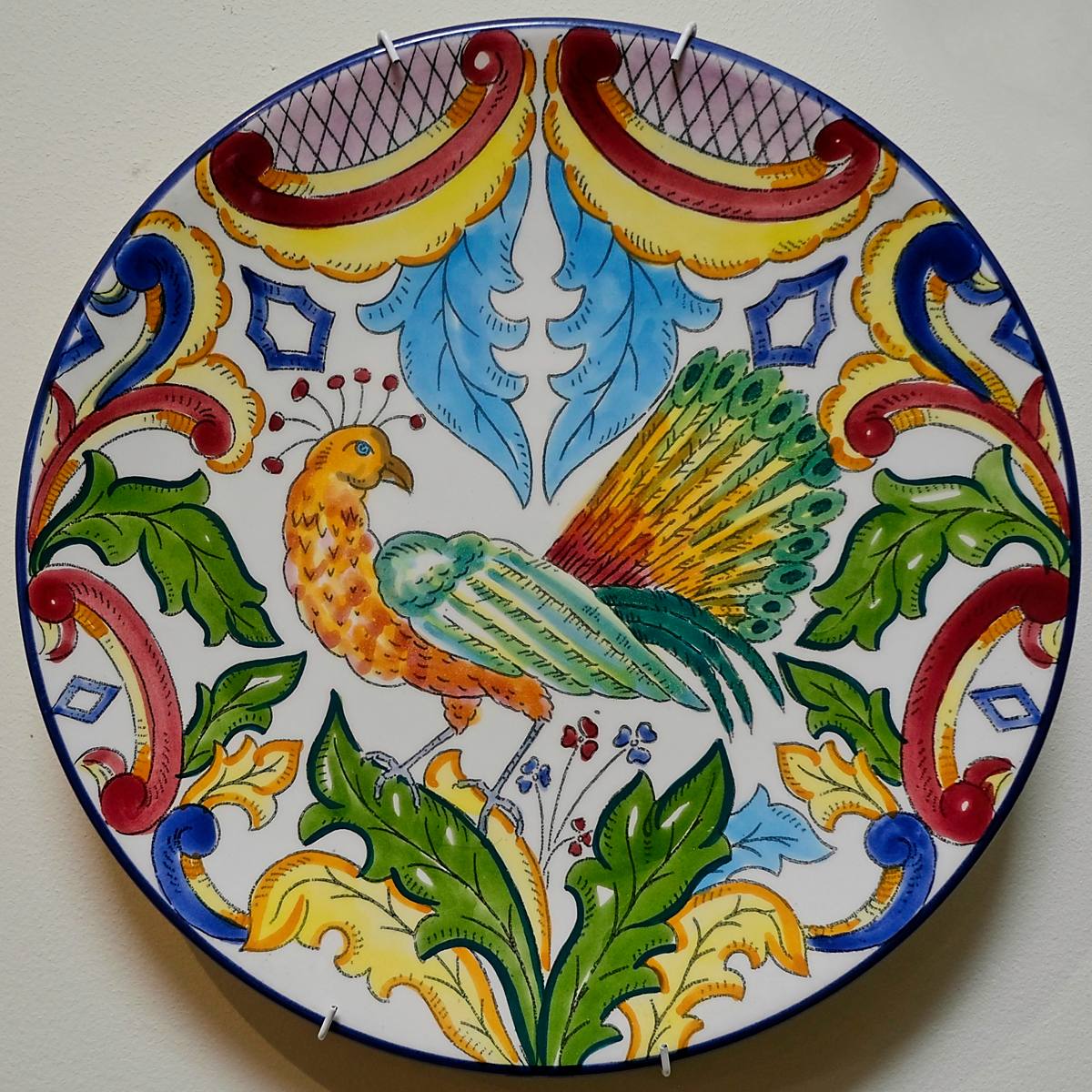 A brightly painted plate with a peacock