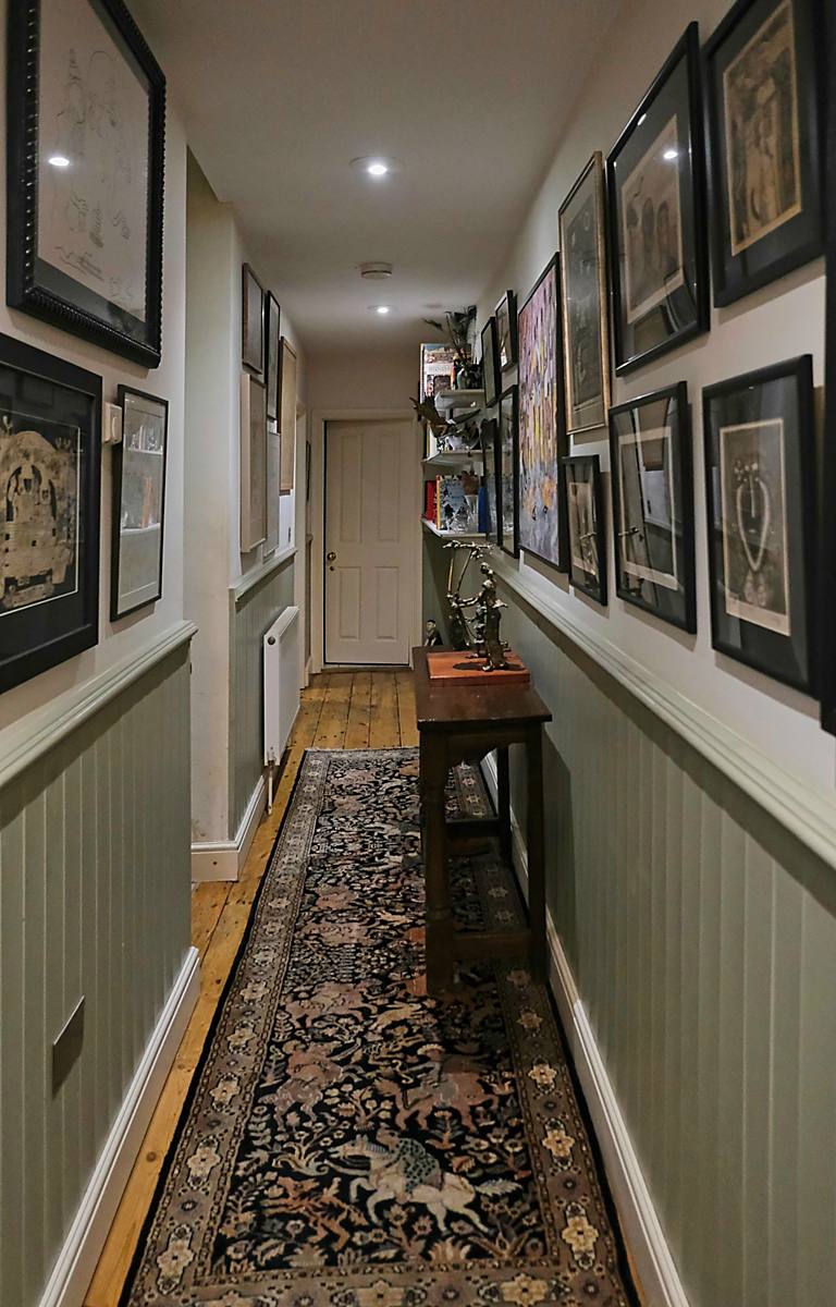 A hallway lined with framed pictures